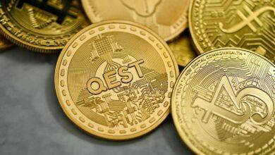 a pile of gold bitcoins sitting on top of each other