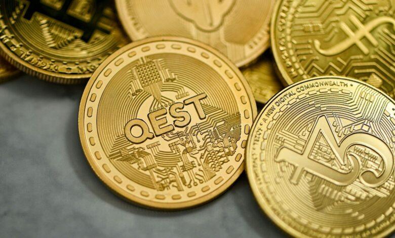 a pile of gold bitcoins sitting on top of each other