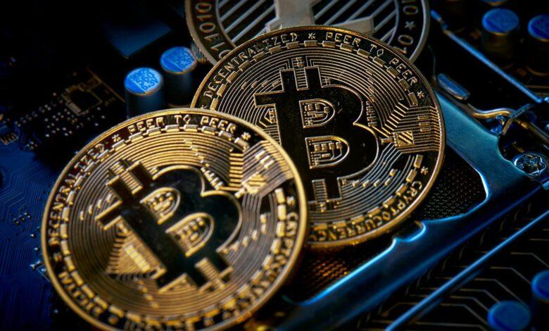 three bitcoins sitting on top of a computer motherboard